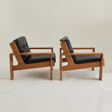 Esko Pajamies Finnish Leather and Oak "Bonanza" Lounge chairs, 1960's, a pair.