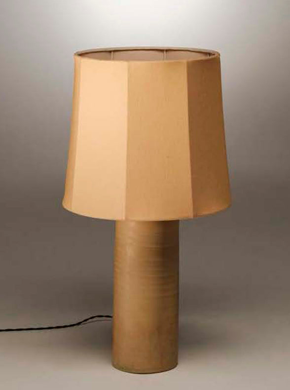Terracotta table lamp with a fluted sand linen shade on a rounded base against a gray background